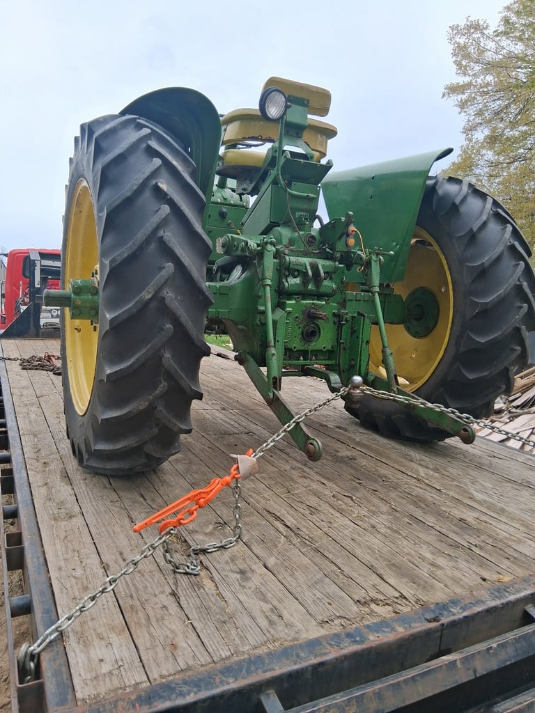 tractor hauling on bed of truck